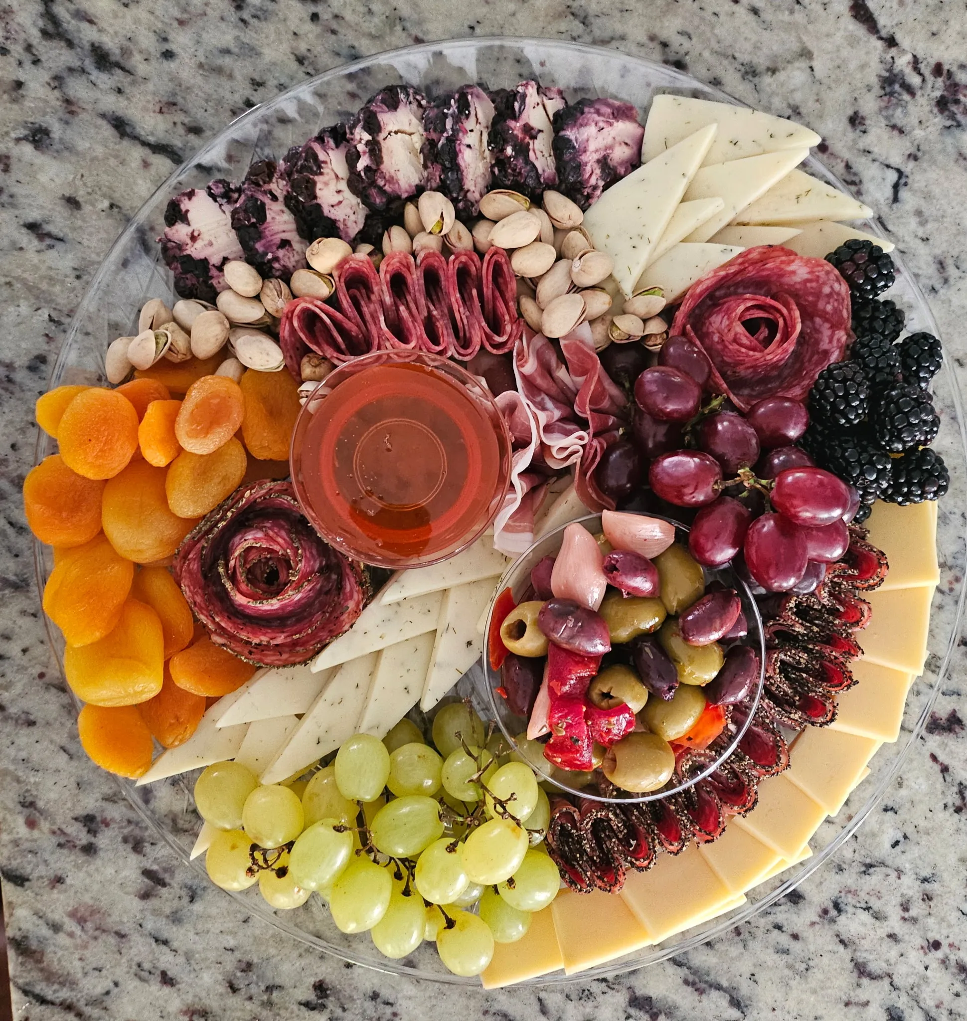 Signature grazing platter — cured meats, cheeses, fruit, olives, and honey